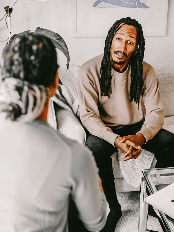 man explaining to woman in a therapy session